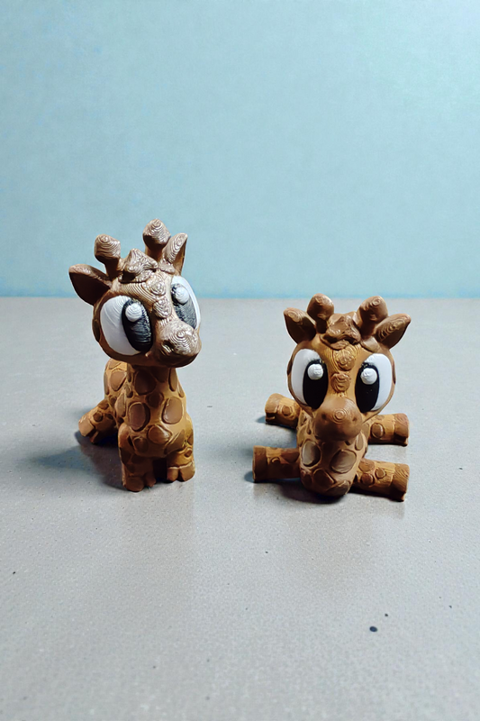 Yellow baby giraffe with brown spots and articulated neck