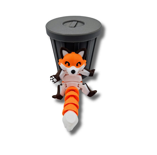 Orange articulated fox figurine emerging from trash can