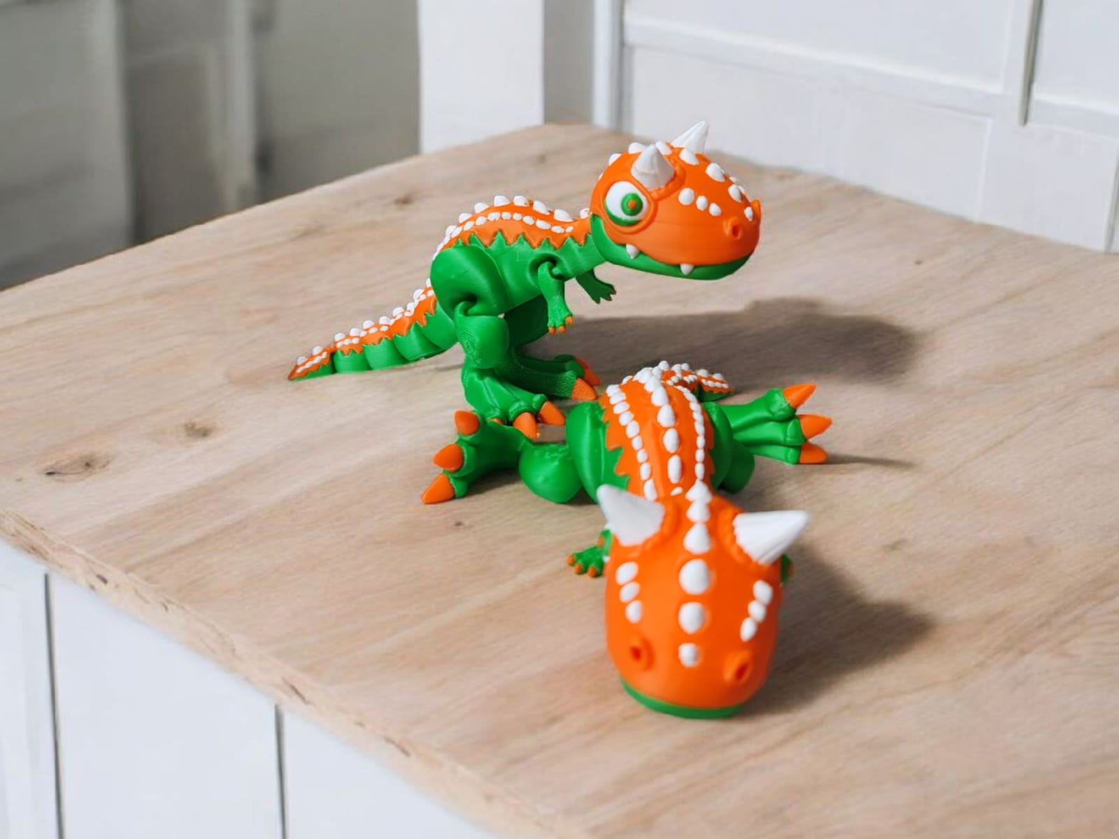 Orange Carnotaurus dinosaur with horns and articulated body