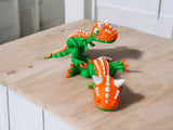 Orange Carnotaurus dinosaur with horns and articulated body