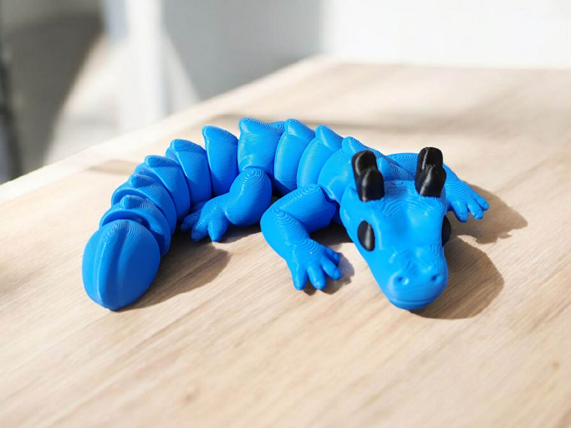 Blue articulated dragon with flexible body and wings
