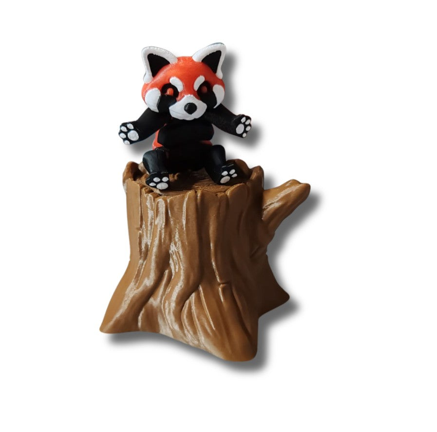 Red panda figurine with striped tail on tree stump