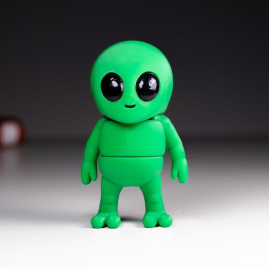 Green flexible alien figurine with large head