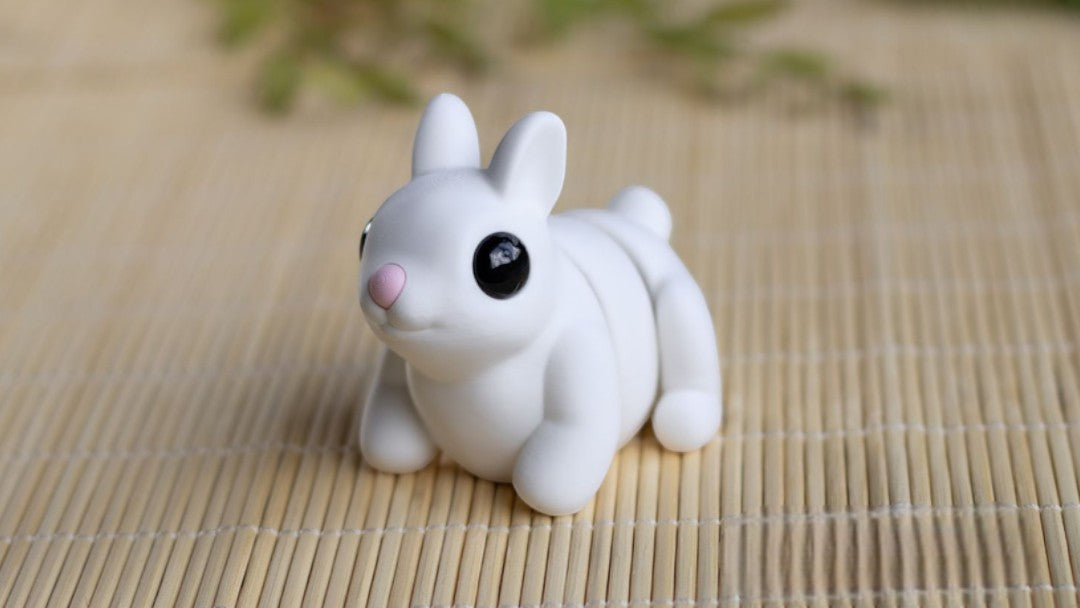 Pink flexible bunny figurine with articulated joints