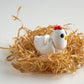 White and red flexible chicken figurine