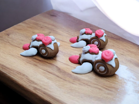 Three cinnamon roll themed articulated turtles in brown and cream colors