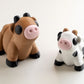 Black and white spotted flexible cow figurine