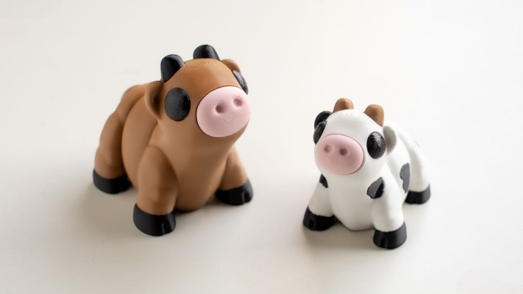 Black and white spotted flexible cow figurine