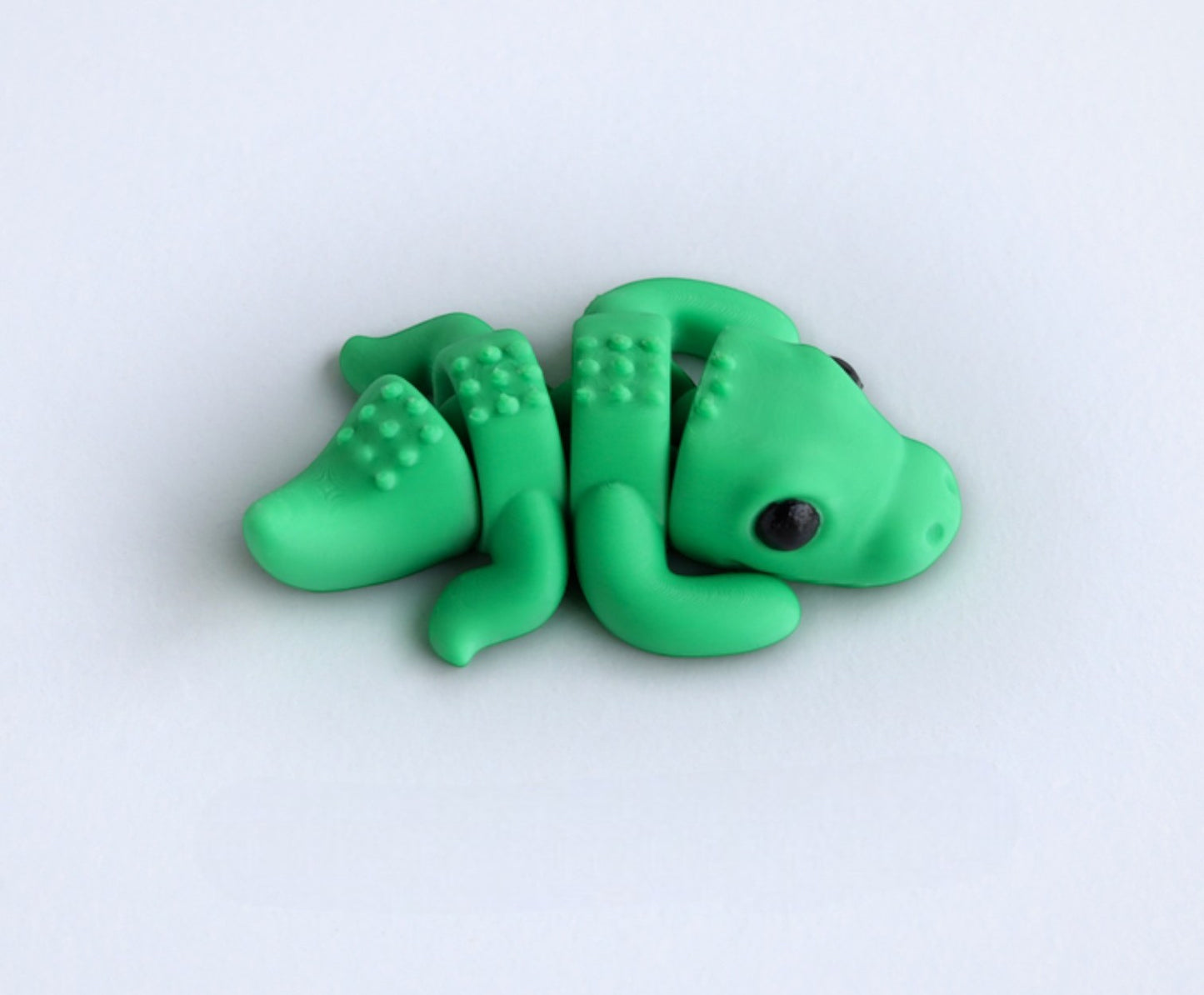 Gray flexible crocodile figurine laying pose