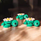 Three daisy flower themed articulated turtles with white and yellow petals