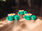 Three daisy flower themed articulated turtles with white and yellow petals