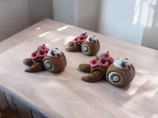 Three coffee and donut themed articulated turtles with brown and pink colors
