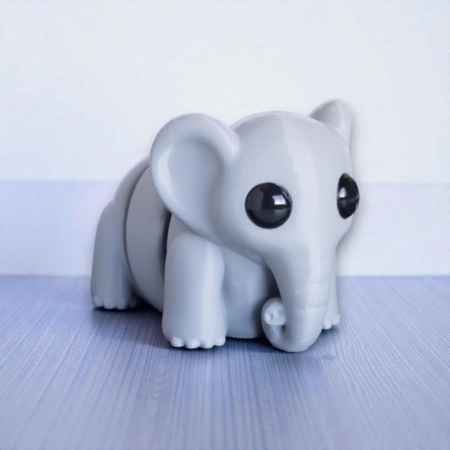 Gray flexible elephant figurine with moveable trunk