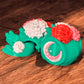 Pink and purple flower turtle with articulated petals on shell