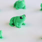 Green flexible frog figurine in sitting pose