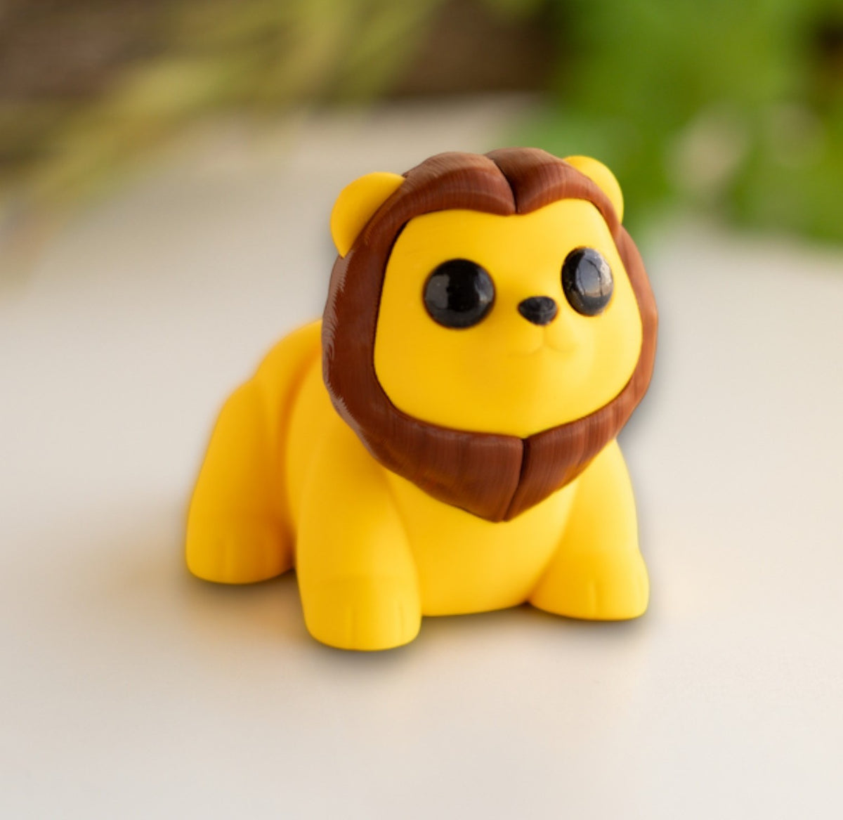 Orange flexible lion figurine with articulated body