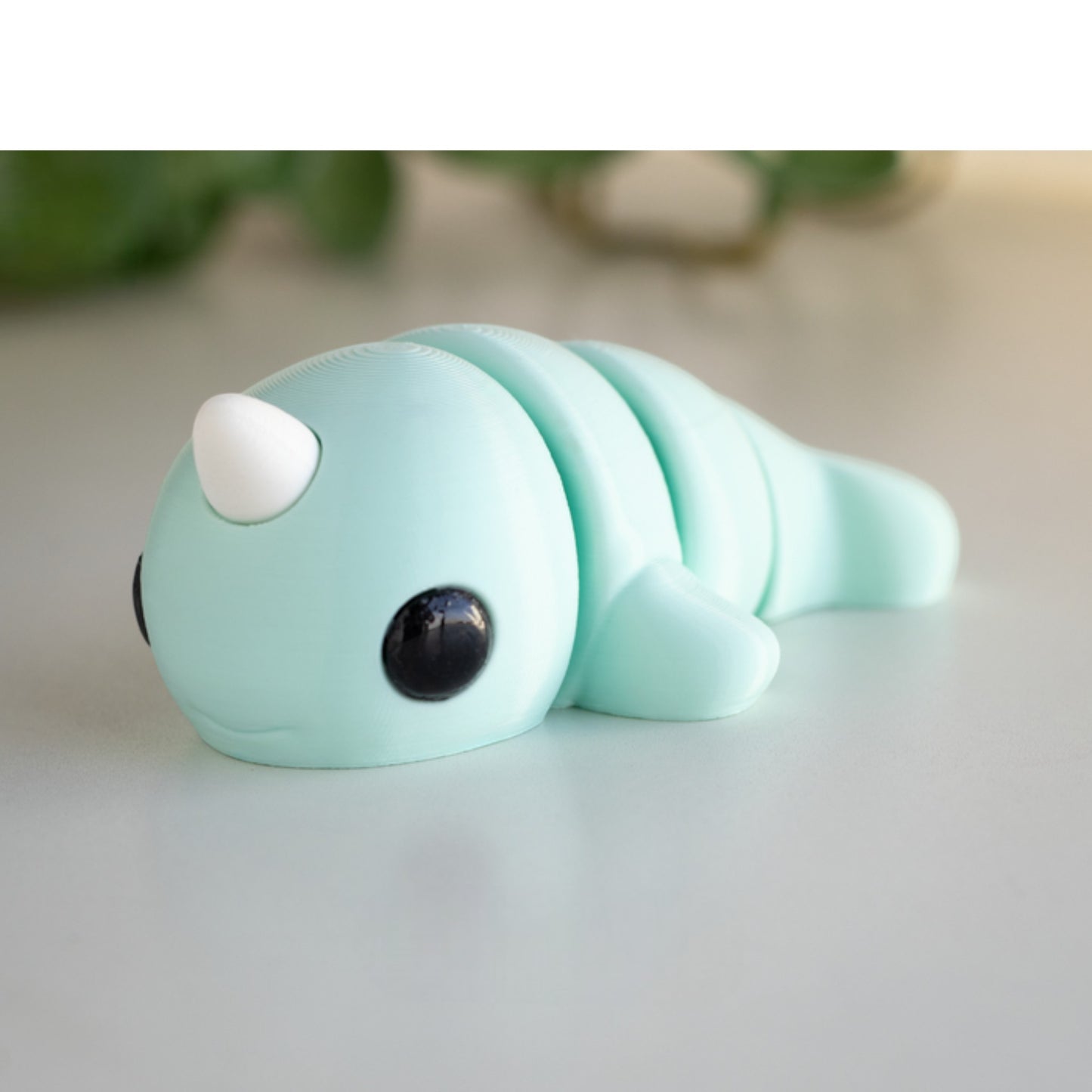 White flexible narwhal figurine with horn