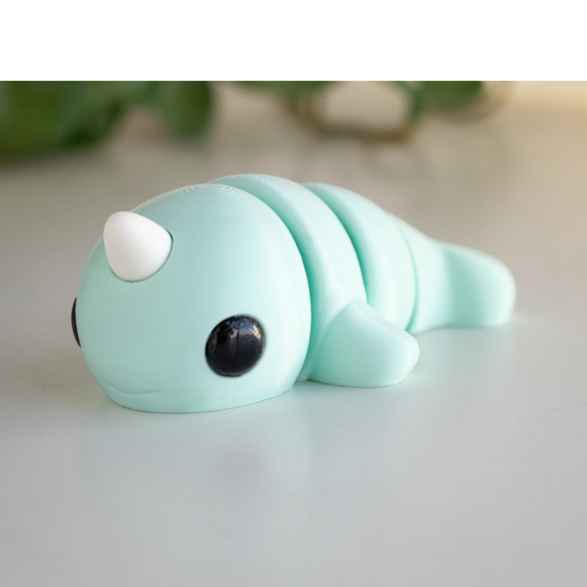 White flexible narwhal figurine with horn