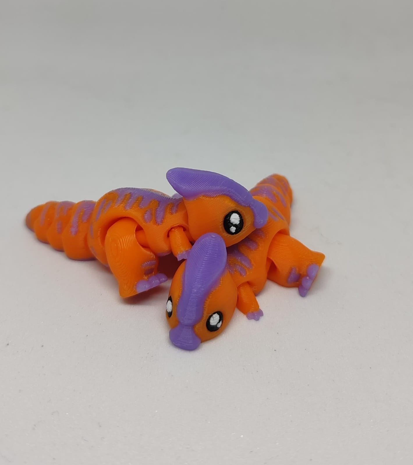 Small orange Parasaur dinosaur hatchling with articulated joints