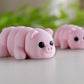 Pink flexible pig figurine with articulated joints