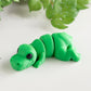 Green flexible T-Rex dinosaur figurine with articulated jaw