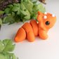 Orange flexible Triceratops dinosaur figurine with three horns