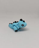 Small blue T-Rex dinosaur hatchling with articulated body