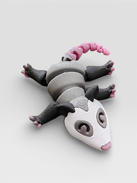 Gray possum on display base showing poseable design