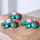 Three colorful flower themed articulated turtles with petal designs